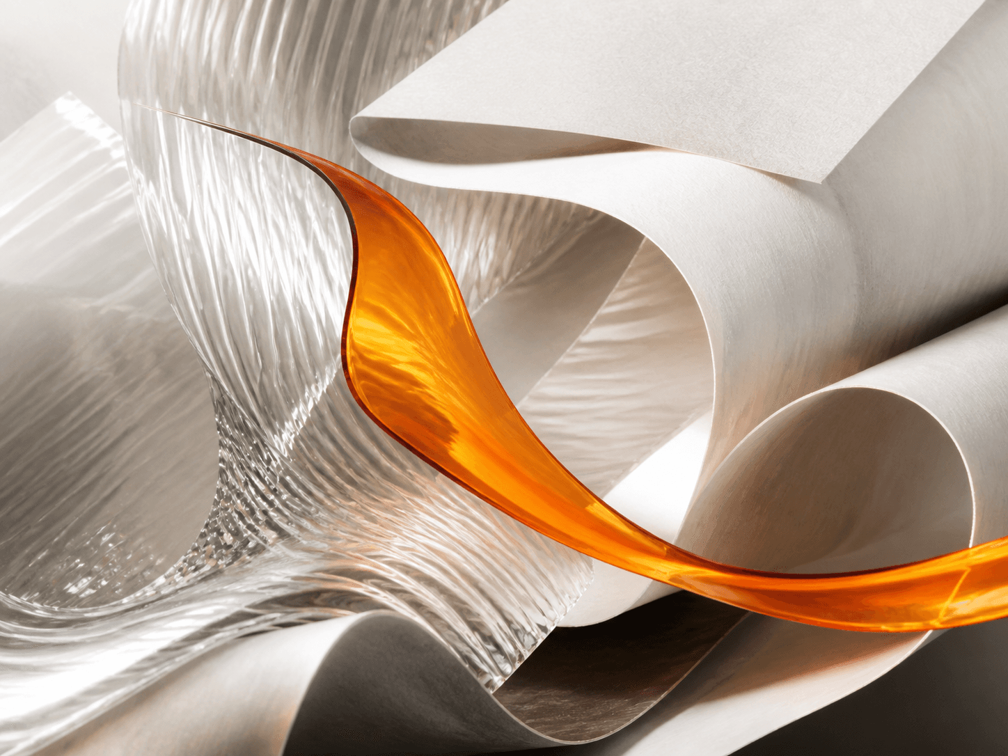 Abstract fluted glass, folded paper, and orange resin representing the Mythos creative process